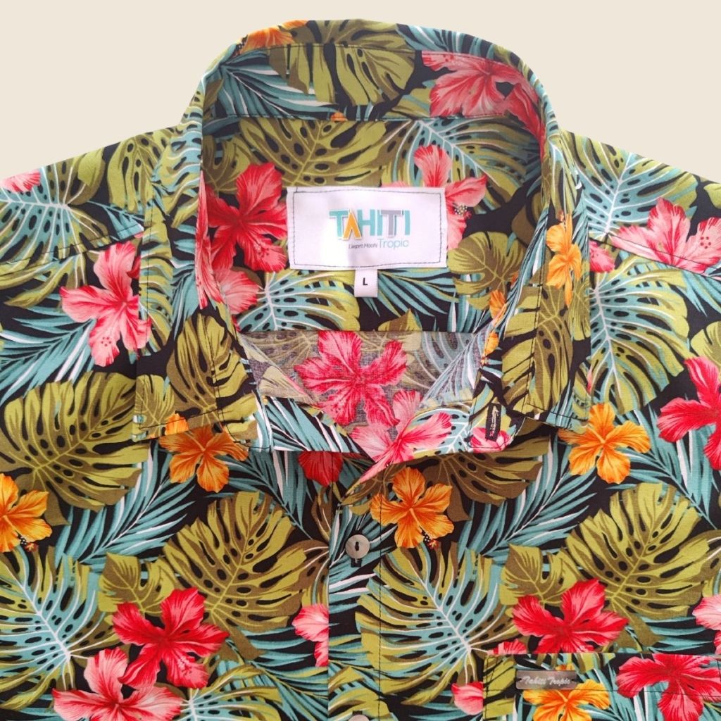 Chemise tahitienne hibiscus rose et orange sur fond noir. Chemise en coton manches courtes, tissu tahitien et boutons en nacre. Edition limitée